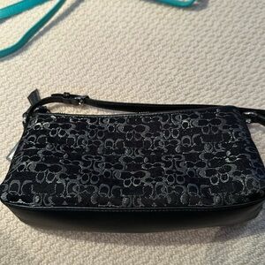 Coach small bag black with silver coach logo fabric.
